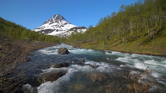 Static view of rapids high up in the Lyngen alps, sunny, summer day, in North Norway