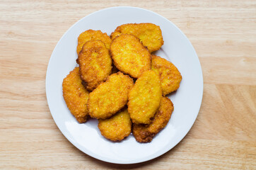 Panamanian style sweet corn fritters on wooden background