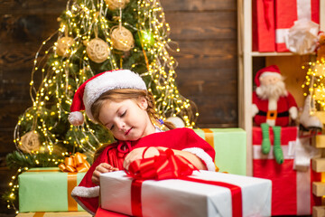 Gift emotions. Christmas kids - happiness concept. Winter kid. New year concept. Happy child with Christmas gift box. Happy child with Christmas gift.