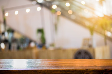 Brown wooden table blurred interior restaurant  background, display for product montage.
