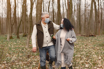 Fototapeta premium Seniors in a forest. People walks. Coronavirus theme.