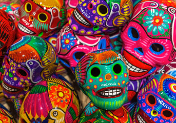 Fototapeta na wymiar Colorful Mexican skull ceramic handicraft for sale on a local art and craft market, Mexico City, Mexico.