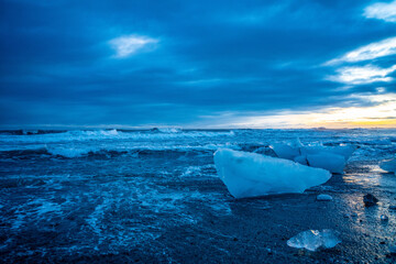 Diamond beach, a black beach with big ice cubes on it, in south coast of Iceland, at sunset.