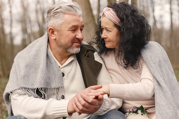 Seniors in a forest. People walks. Family with spring's flowers.