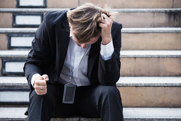 Depressed sad American businessman in formal uniform shout in staircase step in city. Work problem,...