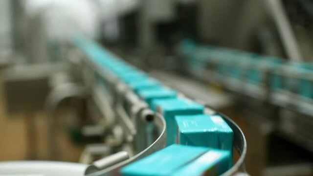Dairy products factory. Cartons of milk. Conveyor for milk packaging.