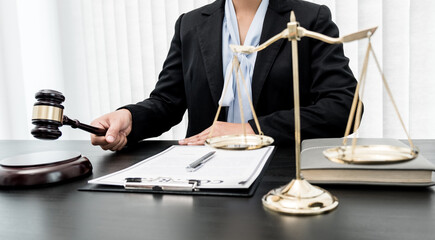 Professional women lawyers work at a law office There are scales, Scales of justice, judges gavel, and litigation documents. Concepts of law and justice