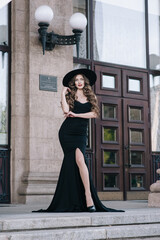 Obraz premium Ukrainian girl in a black dress outdoors in a hat