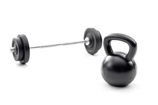 Strength training, bodybuilding and muscle hypertrophy concept with photograph of barbell and kettle bell isolated on white background