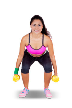 Indian beautiful woman lifting two dumbbells