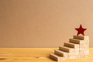 Red star on wood block stairs with brown background. Business development, growth, success concept. with copy space