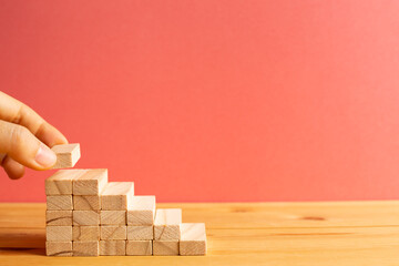 Wood block stairs with pink background. Business development, growth, success concept. with copy space
