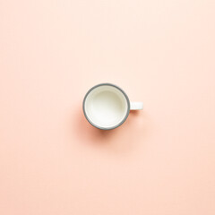 White empty mug cup on pink background. top view