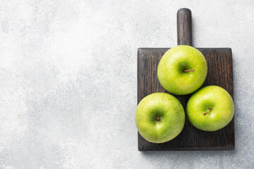 Ripe green apples on a gray concrete background. copy space.