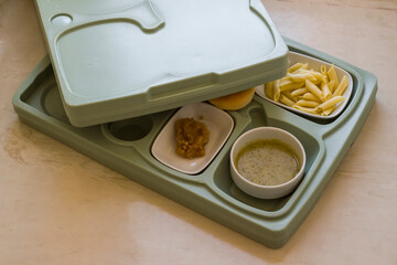 Hard plastic hospital food tray with foods.Top view.