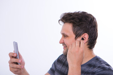 the guy puts a wireless headset in his ear and starts talking on the phone using a video link. Man and modern technologies. listening to music