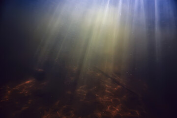 Obraz premium rays of light under water, abstract marine background nature landscape rays blurred