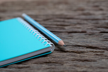 Pencil and book mockup on the old wood desk at the background