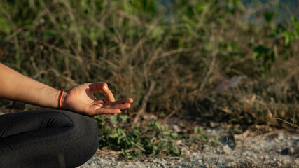 Young woman doing yoga outdoors with amazing back view. Bali. Indonesia.