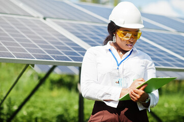 African american technician check the maintenance of the solar panels. Black woman engineer at...