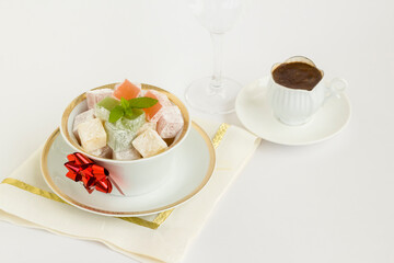 Traditional Turkish Delight on white background with Turkish Coffee.The Sugar Festival