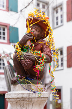 Switzerland, Basel, March 3rd 2020. Basel carnival cancelled due to corona virus pandemic. Decorated monkey statue on a fountain