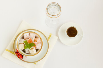 Traditional Turkish Delight on white background with Turkish Coffee.The Sugar Festival.