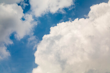 Sky background. White clouds shining through the blue sky