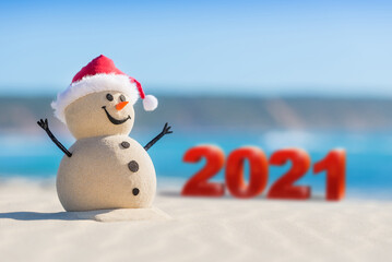 Sandy Christmas Snowman is celebrating  the New Year on a beautiful beach with 2021 3d text, concept for new year 2021