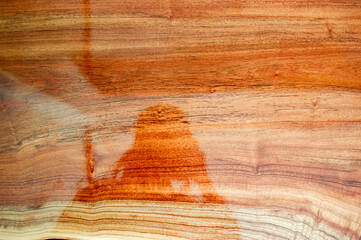 The background image of the plank made of varnish, giving a clear reflection.