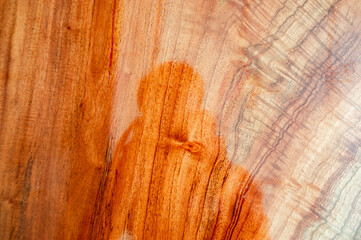 The background image of the plank made of varnish, giving a clear reflection.