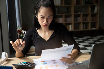 Business and Financial Planning Concept. Financial advisor planning and calculate budget, work on laptop. Professional Businesswoman discusses and analysis annual report at home office.