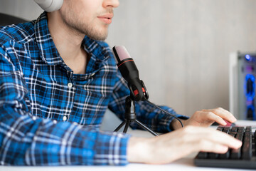 young male handsome host recording podcast in the studio, streaming live