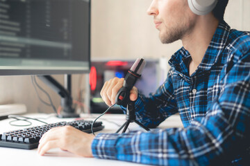 young male handsome host recording podcast in the studio, streaming live