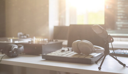 small music production studio equipment close up, record player, midi drum pad mixer and microphone