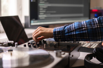 Obraz na płótnie Canvas man in the home music studio, creating new song, making sound production with vintage equipment