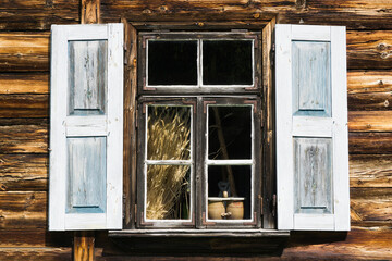 Fototapeta na wymiar Wooden window background. Rustic cottage house wall. Vintage cabin white paint shutters. Countryside architecture texture.