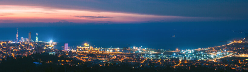 Batumi, Adjara, Georgia. Panorama, Aerial View Of Urban Cityscape At Sunset. Town At Evening Blue Hour time. City And Port In Night Lights Illuminations