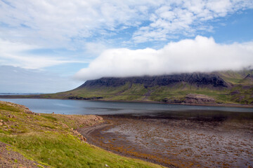 Cliff wrapped in clouds along a fjord (Altafjordur) in Western Iceland