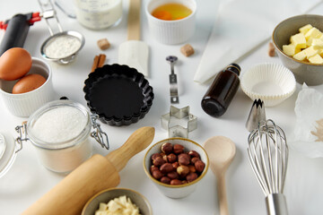 food, culinary and recipe concept - cooking ingredients and kitchen tools for baking on table