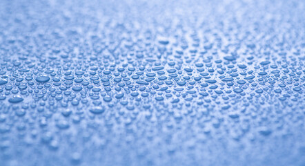 Water drops on a colored background. Raindrops, steam or condensation. Water drops background close up