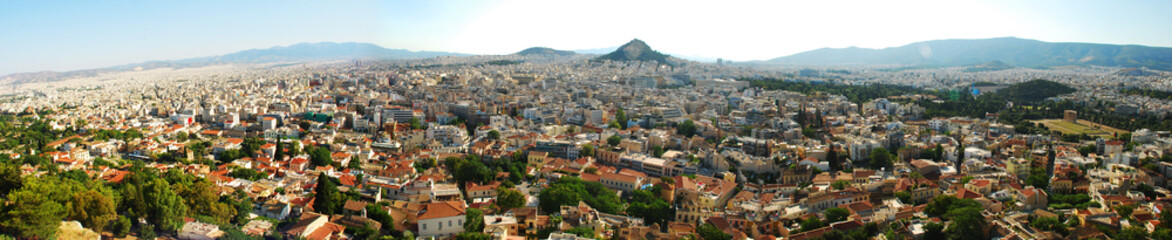 Fototapeta na wymiar Panorama of the city of Athens. The capital of Greece is Athens. The view from the top to the big city, mountains are visible in the distance.