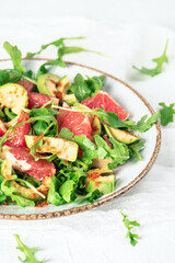 Fresh salad with arugula, avocado and grapefruit