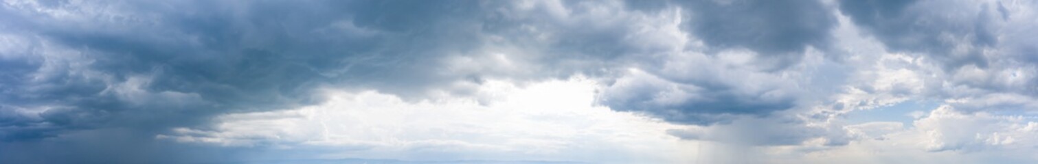 Overcast sky with rain, weather conditions and forecast. Dramatic ultra-wide panoramic background...