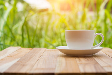 Coffee espresso on wood table nature background in garden,warm tone