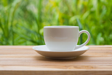 Coffee espresso on wood table nature background in garden,warm tone