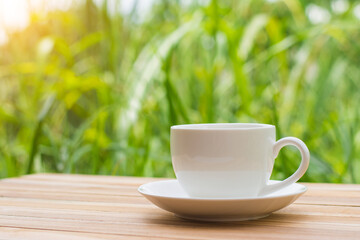 Coffee espresso on wood table nature background in garden,warm tone