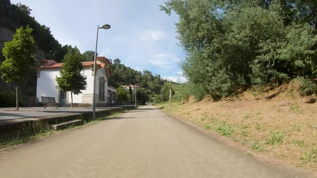 Point of view shot of riding a bicycle at Amarante Cycling Trail in Portugal. Features a wide view of the bike track and the natural scenery as it travels.