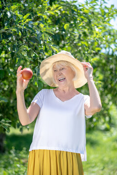 Smiling elderly woman prouding with her harvest