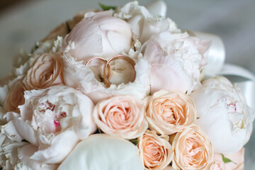 bright wedding bouquet of summer flowers  with wedding rings